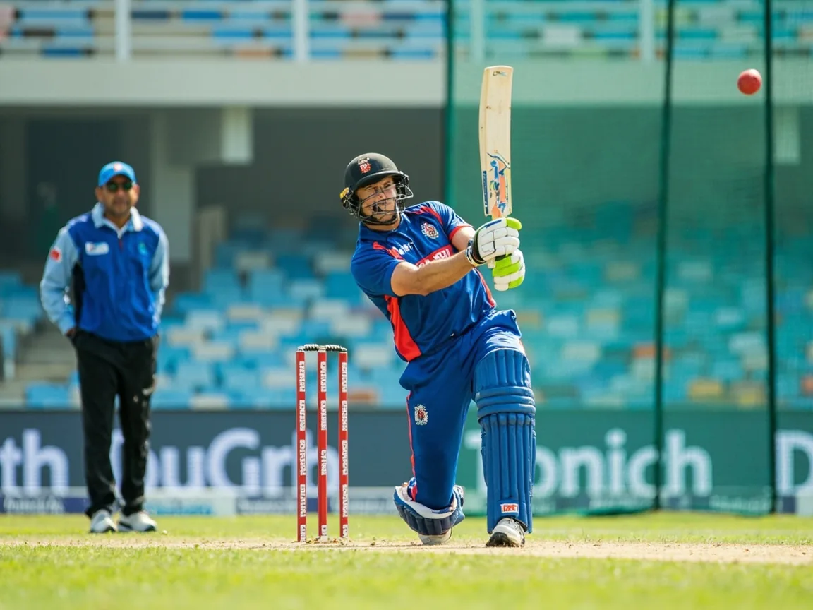 Wicketkeeper batter playing a controlled cover drive in practice nets